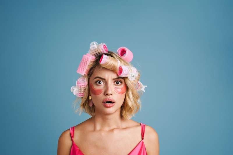 Salon client with hair curlers