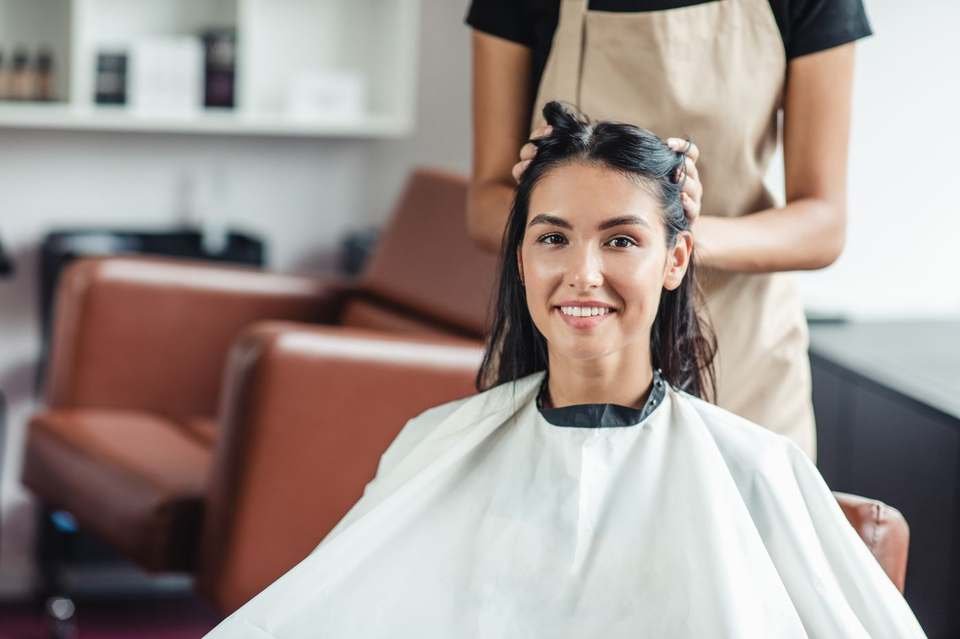 Client getting hair styled in a salon
